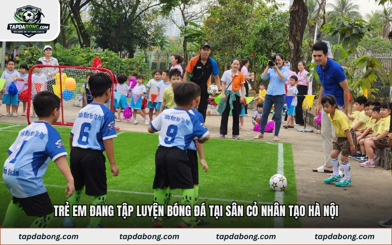 Trẻ em đang tập luyện bóng đá tại sân cỏ nhân tạo Hà Nội